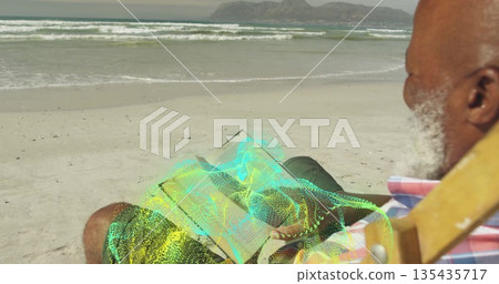 Reading senior Black man sitting on wooden beach chair at shore holding hologram book, copy space 135435717