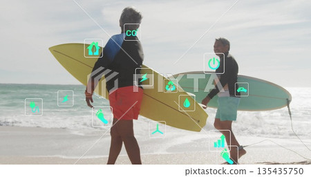 Walking senior couple carrying yellow and green surfboards in surfwear at beach shore Walking senior couple carrying yellow and green surfboards in surfwear at beach shore 135435750
