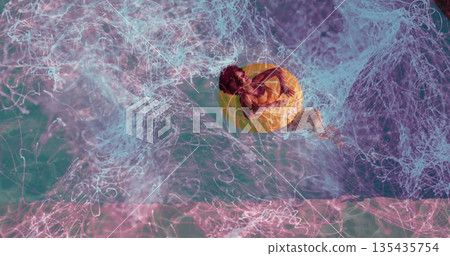 Reclining Black woman drifting on yellow inflatable ring on turquoise water, swirling neon trails Reclining Black woman drifting on yellow inflatable ring on turquoise water, swirling neon trails 135435754