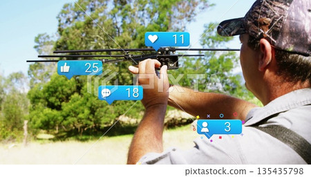 Adjusting man in baseball cap tuning black drone amid trees with social media icons, copy space Adjusting man in baseball cap tuning black drone amid trees with social media icons, copy space 135435798