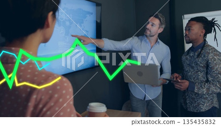 Presenting professionals pointing at digital map display in boardroom with laptop tablet coffee cup Presenting professionals pointing at digital map display in boardroom with laptop tablet coffee cup 135435832