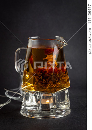 Hot tea in a cup on an old background. Hot tea in a cup on an old background. 135436427
