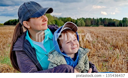 Portrait of a young woman and child. Mom and her boy kid spending time together on nature. Mom and son spend time together in nature. Quality time with child. Portrait of a young woman and child. Mom and her boy kid spending time together on nature. Mom and son spend time together in nature. Quality time with child. 135436437