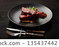 Spare ribs served on a black plate 135437442