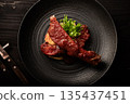 Spare ribs on a black plate 135437451