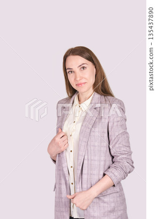 Young caucasian female professional in plaid blazer and white shirt smiling 135437890