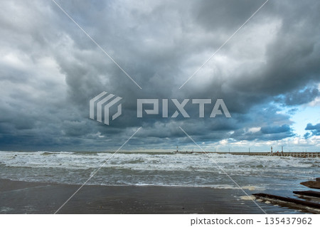 Wild coastal scene under dark menacing skies and tumultuous Wild coastal scene under dark menacing skies and tumultuous 135437962