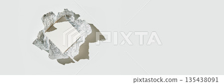 Aluminum foil torn open revealing white blank page centered on light background 135438091