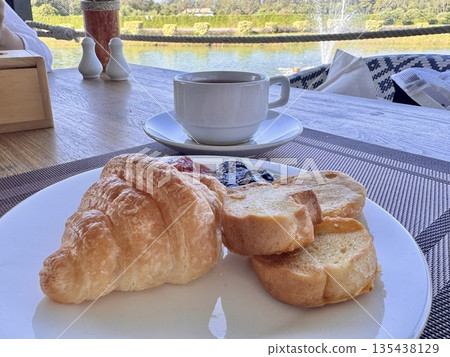 European breakfast croissants with strawberry and blackberry jam and aromatic coffee 135438129