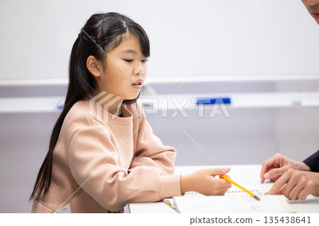 Profile of an elementary school girl studying Profile of an elementary school girl studying 135438641