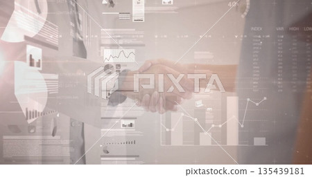 Shaking hands Hispanic woman and man wearing business attire in office, with bar and line charts 135439181