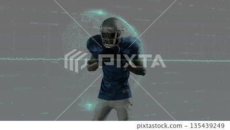 Standing male football player wearing helmet and shoulder pads in studio, with teal data particles 135439249