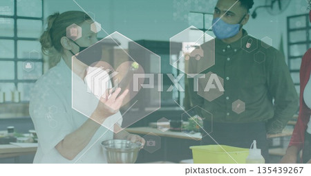 Masked chef holding eggplant and mixing bowl in professional kitchen, with digital health icons Masked chef holding eggplant and mixing bowl in professional kitchen, with digital health icons 135439267
