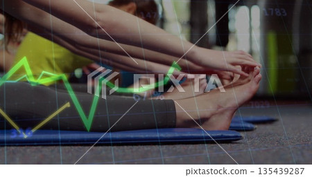 Stretching fitness students reaching toes on gym floor, with blue mats, leggings and chart overlay 135439287
