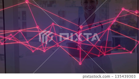 Displaying female doctor standing with white coat and stethoscope in office with pink graph overlay Displaying female doctor standing with white coat and stethoscope in office with pink graph overlay 135439303