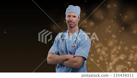 Standing mid adult man wearing light blue scrubs and cap crossing arms in studio, with stethoscope Standing mid adult man wearing light blue scrubs and cap crossing arms in studio, with stethoscope 135439311