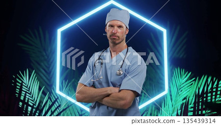 Posing doctor wearing blue scrubs on set, with neon hexagon palm fronds and stethoscope Posing doctor wearing blue scrubs on set, with neon hexagon palm fronds and stethoscope 135439314