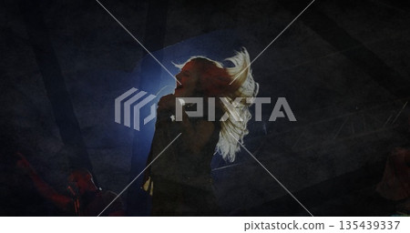 Performing female singer in dark top holding microphone and singing on stage, with lights and haze Performing female singer in dark top holding microphone and singing on stage, with lights and haze 135439337
