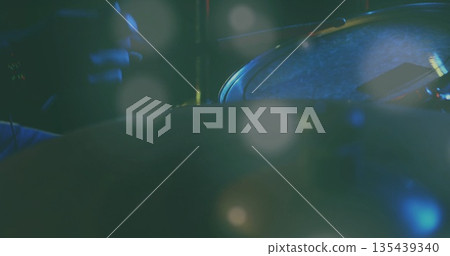 Highlighting snare drum head with drumstick, smartphone and metal rim under stage light, copy space 135439340