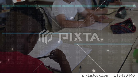 Schoolboy wearing red shirt with braided hair writing in notebook in classroom, copy space Schoolboy wearing red shirt with braided hair writing in notebook in classroom, copy space 135439440