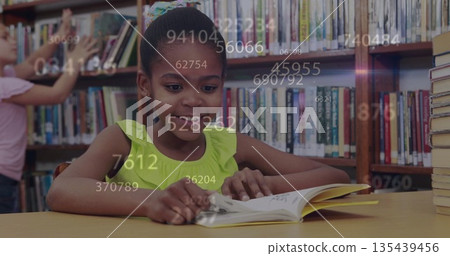Reading girl wearing lime green top studying open book at library table, with numeric overlays 135439456
