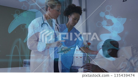 Examining medical team reviewing patient data on tablet in hospital room, with holographic graphics Examining medical team reviewing patient data on tablet in hospital room, with holographic graphics 135439474