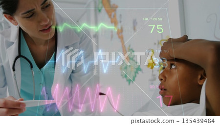 Examining doctor checking boy patient at pediatric clinic, with thermometer and holographic vitals 135439484