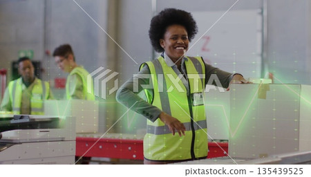 Handling Black woman in yellow vest placing box on conveyor in warehouse with packaging machine Handling Black woman in yellow vest placing box on conveyor in warehouse with packaging machine 135439525