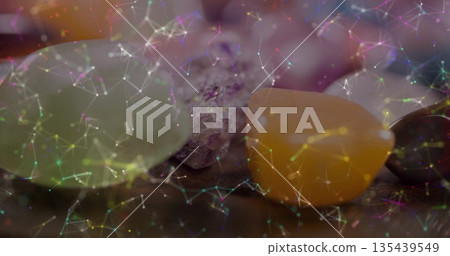 Displaying three polished stones resting on dark wooden tabletop, with glowing network overlay Displaying three polished stones resting on dark wooden tabletop, with glowing network overlay 135439549