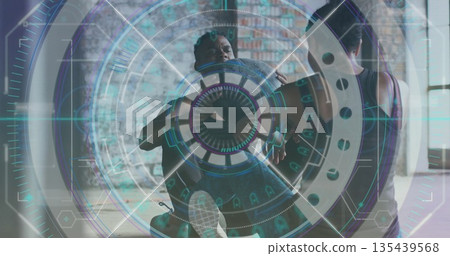 Workout pair performing ab crunches and passing medicine ball in loft fitness studio, in sportswear Workout pair performing ab crunches and passing medicine ball in loft fitness studio, in sportswear 135439568