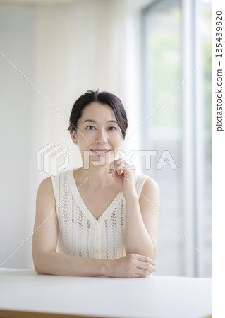 Beauty image portrait of a woman in her early 50s smiling at the camera 135439820