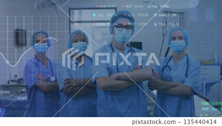 Standing surgical team wearing blue scrubs in OR, showing stethoscopes, monitors and data overlays Standing surgical team wearing blue scrubs in OR, showing stethoscopes, monitors and data overlays 135440414