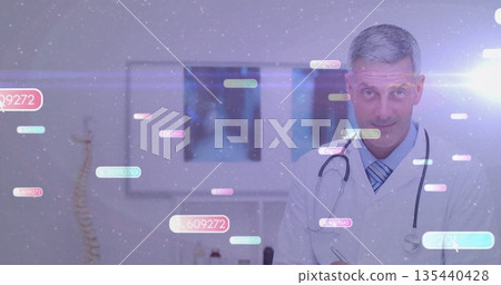 Male doctor reviewing x-ray on viewer in clinic, with stethoscope, spine model overlays, copy space Male doctor reviewing x-ray on viewer in clinic, with stethoscope, spine model overlays, copy space 135440428