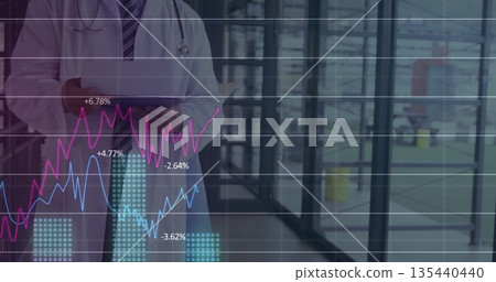 Holding tablet, doctor in lab coat in hospital corridor, with stethoscope, line and bar charts Holding tablet, doctor in lab coat in hospital corridor, with stethoscope, line and bar charts 135440440