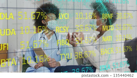 Listening healthcare provider in scrubs wearing mask in consultation room, with tablet and syringe 135440462