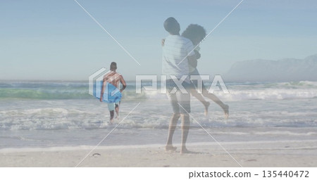Lifting couple above sand on beach, overlaying surfer in turquoise trunks carrying blue bodyboard Lifting couple above sand on beach, overlaying surfer in turquoise trunks carrying blue bodyboard 135440472