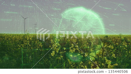 Showing yellow flowering crops covering farmland, with wind turbines and wireframe globe overlay 135440506