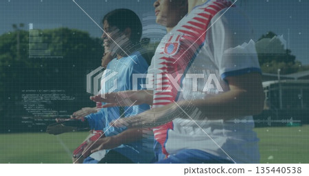 Moving six soccer players coordinating on green grass training ground, with gloves and cones Moving six soccer players coordinating on green grass training ground, with gloves and cones 135440538