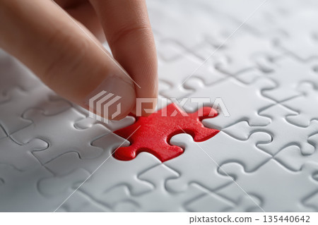 Completing the puzzle concept, placing the last puzzle piece Completing the puzzle concept, placing the last puzzle piece 135440642
