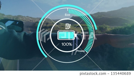 Leaning woman wearing sweater extending arm out car window on rural road, with digital eco gauge 135440689