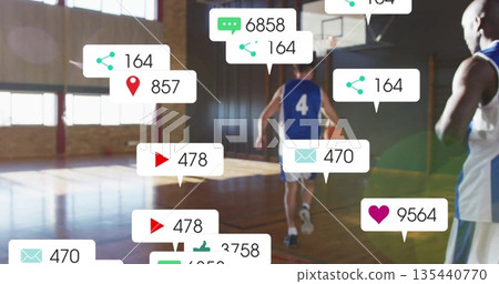 Dribbling man in blue jersey numbered 4 holding basketball at gym, with floating social media icons 135440770