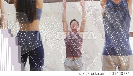 Male trainer wearing tank top and grey pants raising arms overhead in studio, with interface panels 135440775