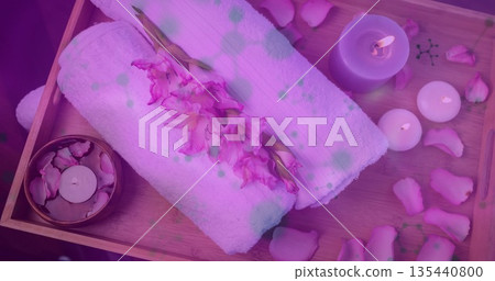 Displaying spa tray on treatment table, holding rolled white towels, pink gladiolus and lit candles Displaying spa tray on treatment table, holding rolled white towels, pink gladiolus and lit candles 135440800