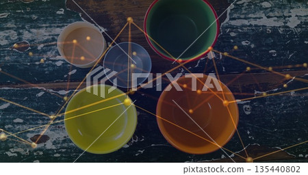 Displaying bowls with green bowl with red rim on chipped green table, with golden network overlay Displaying bowls with green bowl with red rim on chipped green table, with golden network overlay 135440802