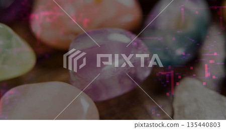 Showcasing gems on wood table, featuring amethyst rose quartz aventurine and blue-white stones Showcasing gems on wood table, featuring amethyst rose quartz aventurine and blue-white stones 135440803