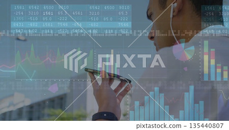 Analyzing financial chart overlays, holding smartphone and wearing earbud on rooftop, copy space 135440807