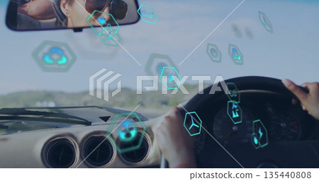 Driving Indian woman wearing sunglasses on rural road holding wheel, with floating hexagonal icons Driving Indian woman wearing sunglasses on rural road holding wheel, with floating hexagonal icons 135440808