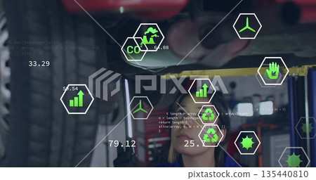 Inspecting mechanic in coveralls examining undercarriage on lift at garage, with green UI icons Inspecting mechanic in coveralls examining undercarriage on lift at garage, with green UI icons 135440810