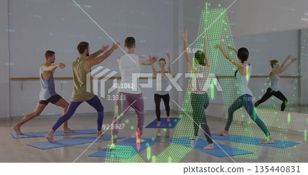 Six adults performing yoga in fitness studio, with blue mats, mirrored barre and green data graphs 135440831