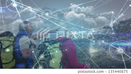 Pointing senior hikers scanning rocky hillside trail with backpacks and digital overlay, copy space Pointing senior hikers scanning rocky hillside trail with backpacks and digital overlay, copy space 135440875